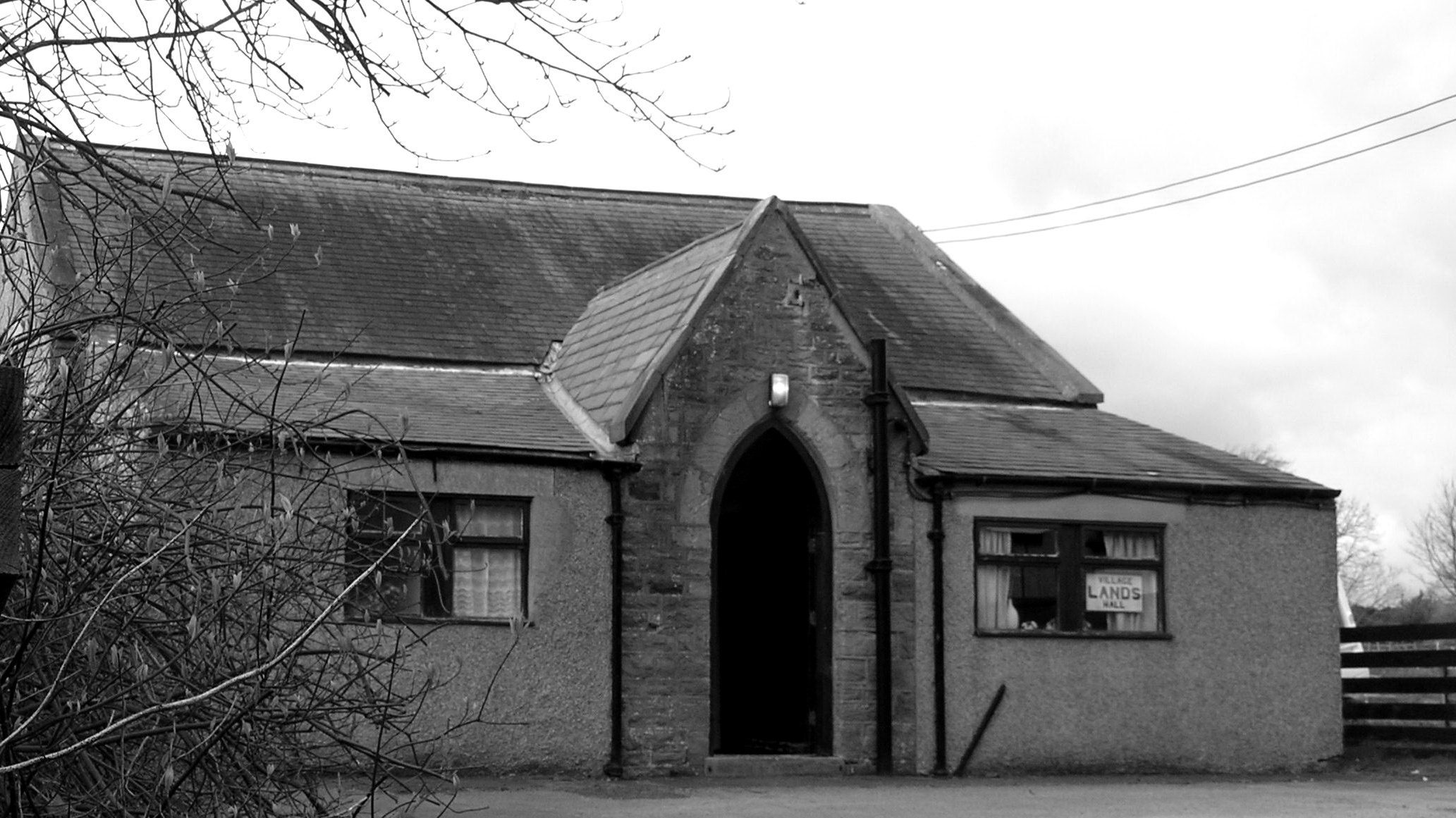 External photograph of Lands Village Hall in monochrome