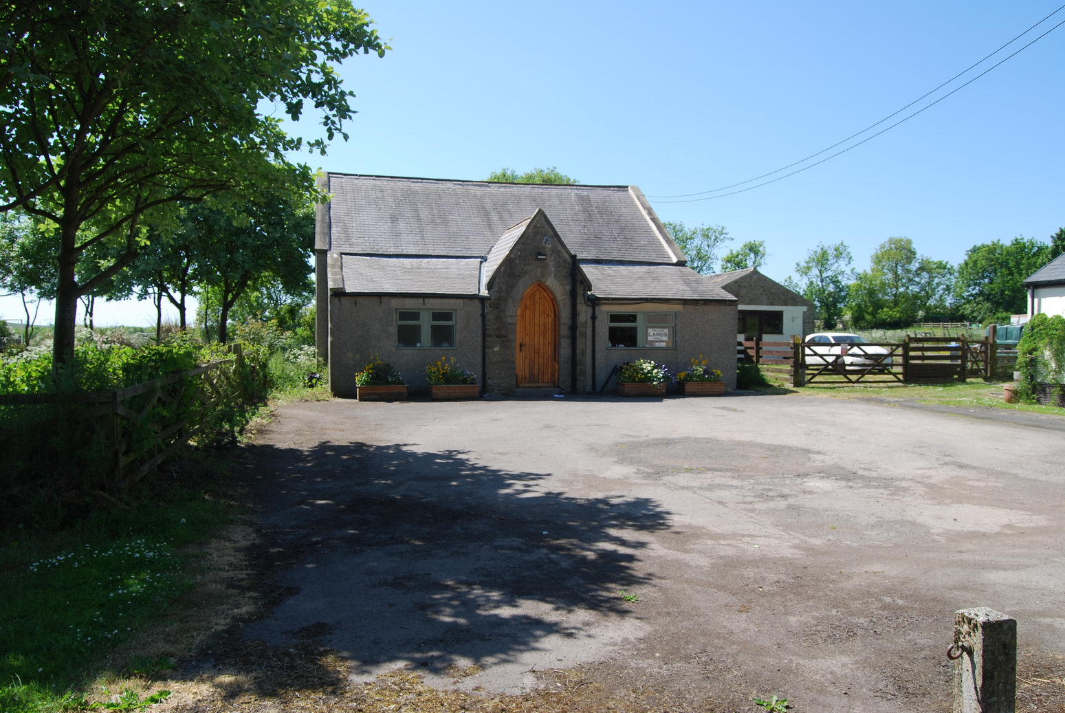 Lands Village Hall is set back from the road by its car park.